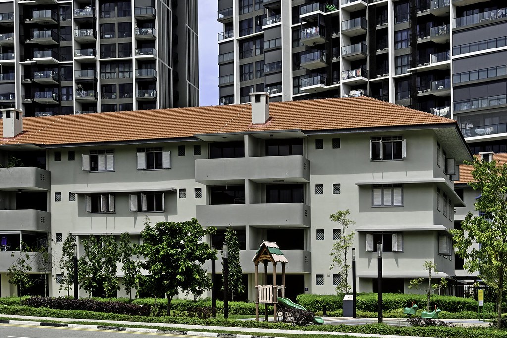 A conserved low-rise block at Avenue South Residence with residential towers behind, photographed in 2025