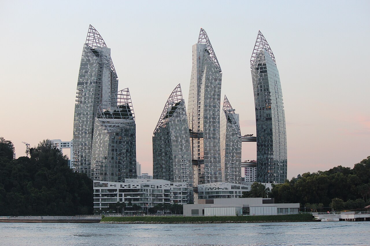 The curved residential towers of Reflections at Keppel Bay beside the water